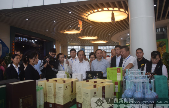 嘉宾们在了解金花茶系列产品。广西新闻网记者周隆富 摄.png